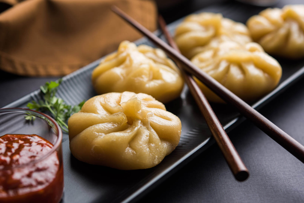 Folding momo sheets to create these dumplings requires a bit of practice